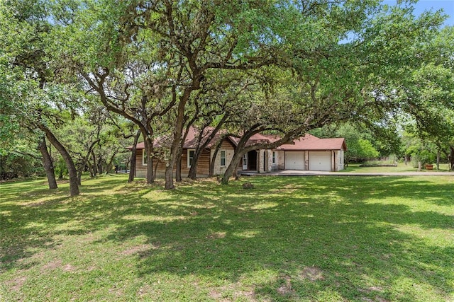104 Tonkawa Cv, Kyle, TX 78640 - view of front of property featuring an attached garage and a front lawn