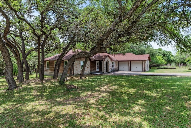 104 Tonkawa Cv, Kyle, TX 78640 - ranch-style home with aphalt driveway, a front yard, and a garage