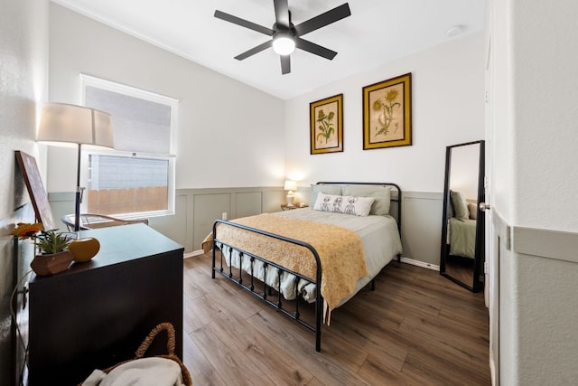 2700 Shimsham Dr, Pflugerville, TX 78660 - bedroom featuring wood finished floors, a wainscoted wall, and ceiling fan