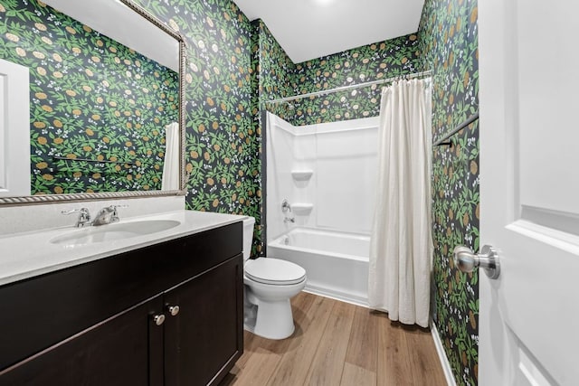 2700 Shimsham Dr, Pflugerville, TX 78660 - full bath featuring wallpapered walls, wood finished floors, toilet, vanity, and shower / tub combo