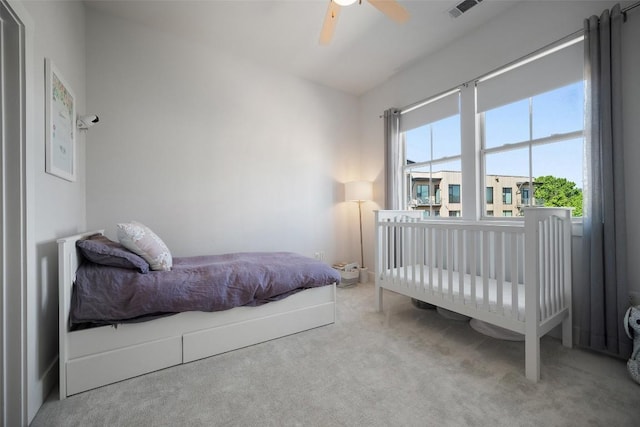 bedroom featuring carpet floors, visible vents, and a ceiling fan