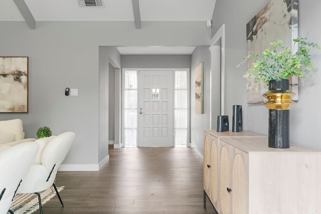 entrance foyer featuring beamed ceiling, wood finished floors, baseboards, and visible vents