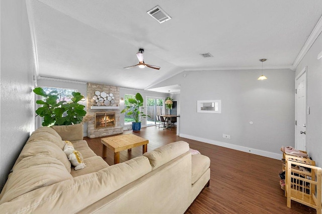 3212 Darnell Dr, Austin, TX 78745 - living room featuring wood finished floors, a ceiling fan, a fireplace, ornamental molding, and vaulted ceiling
