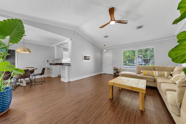 3212 Darnell Dr, Austin, TX 78745 - living area with ceiling fan, ornamental molding, dark wood-style flooring, and vaulted ceiling