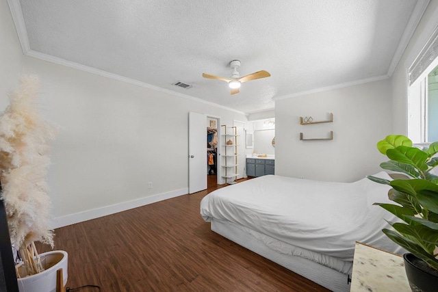 3212 Darnell Dr, Austin, TX 78745 - bedroom with wood finished floors, ornamental molding, a textured ceiling, a ceiling fan, and a spacious closet