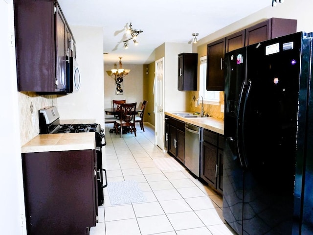 1015 Acanthus St, Pflugerville, TX 78660 - kitchen featuring stainless steel appliances, a sink, a chandelier, light tile patterned flooring, and light countertops