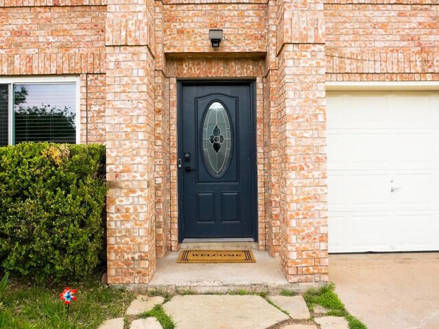 1015 Acanthus St, Pflugerville, TX 78660 - view of exterior entry with brick siding and a garage