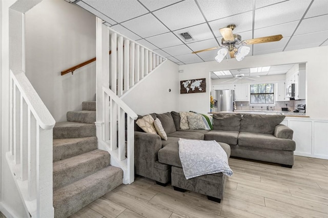 7557 Chaparral Rd, Killeen, TX 76542 - living area with ceiling fan, visible vents, stairs, and a paneled ceiling