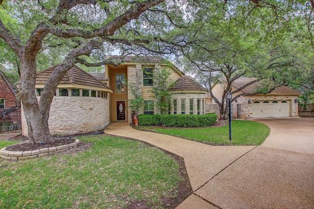 36 Cottondale Rd, The Hills, TX 78738 - tudor home with stone siding, concrete driveway, and a garage