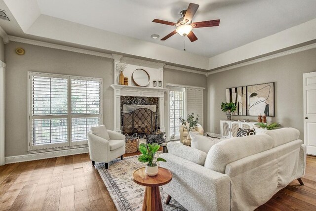 36 Cottondale Rd, The Hills, TX 78738 - living area with ceiling fan, hardwood / wood-style flooring, a premium fireplace, baseboards, and a raised ceiling