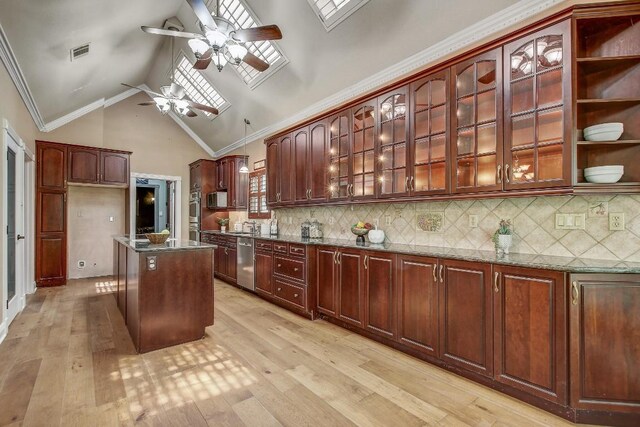 36 Cottondale Rd, The Hills, TX 78738 - kitchen featuring appliances with stainless steel finishes, a ceiling fan, dark stone countertops, light wood-style flooring, and high vaulted ceiling