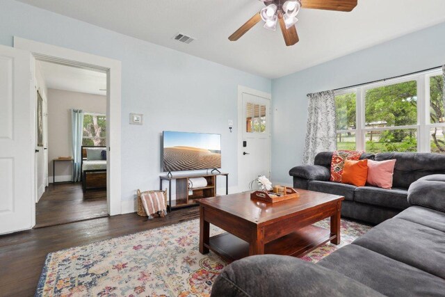 living room featuring ceiling fan, wood finished floors, and visible vents