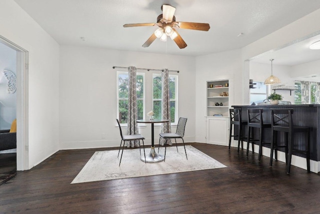 sitting room featuring ceiling fan, wood finished floors, and plenty of natural light