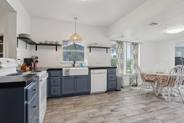 kitchen featuring open shelves, white appliances, a sink, and visible vents