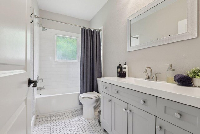 bathroom with shower / bath combo, toilet, and vanity