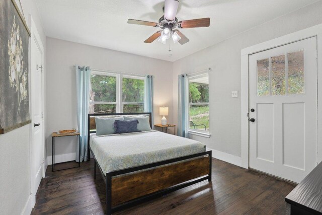 bedroom with baseboards, dark wood-style floors, and ceiling fan
