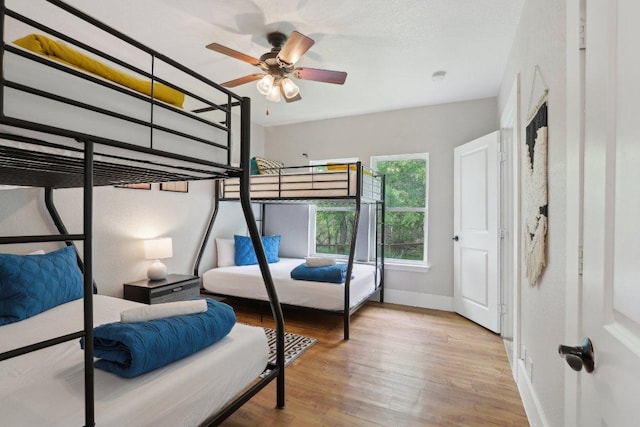 bedroom featuring baseboards and wood finished floors