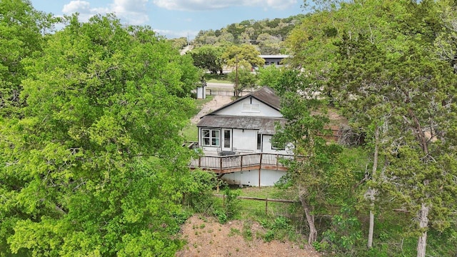 rear view of house featuring a wooden deck