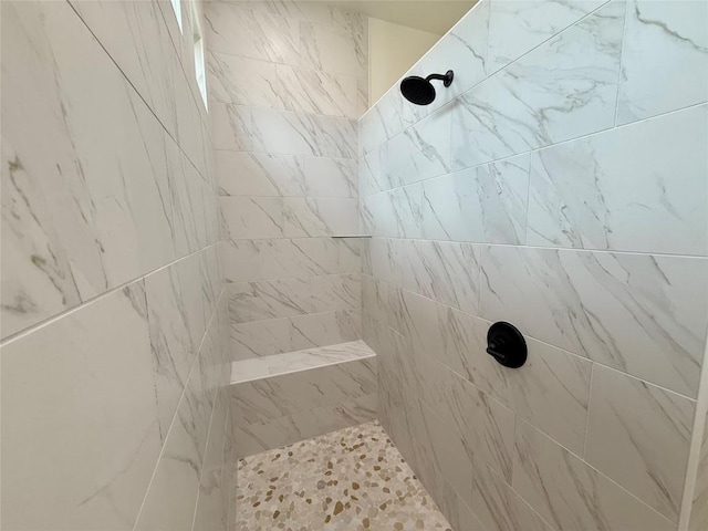 bathroom with tiled shower