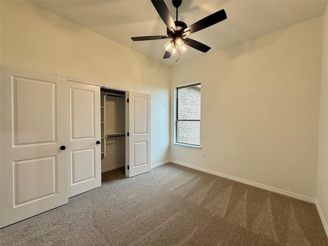 unfurnished bedroom with a closet, carpet flooring, baseboards, and ceiling fan
