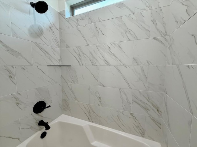 bathroom with bathing tub / shower combination