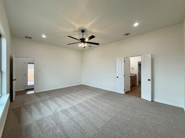 unfurnished bedroom featuring visible vents, carpet flooring, and baseboards