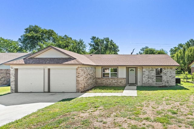 ranch-style home with concrete driveway, brick siding, a front yard, and a garage
