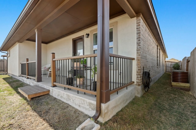 185 Dogvane Cir, Kyle, TX 78640 - view of property exterior featuring stucco siding, stone siding, and a fenced backyard