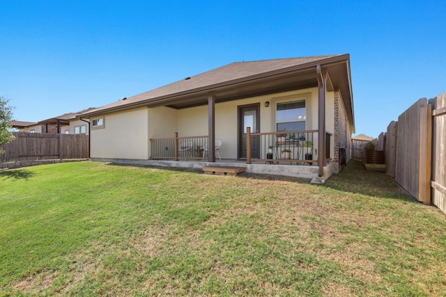 185 Dogvane Cir, Kyle, TX 78640 - rear view of property with stucco siding and a fenced backyard