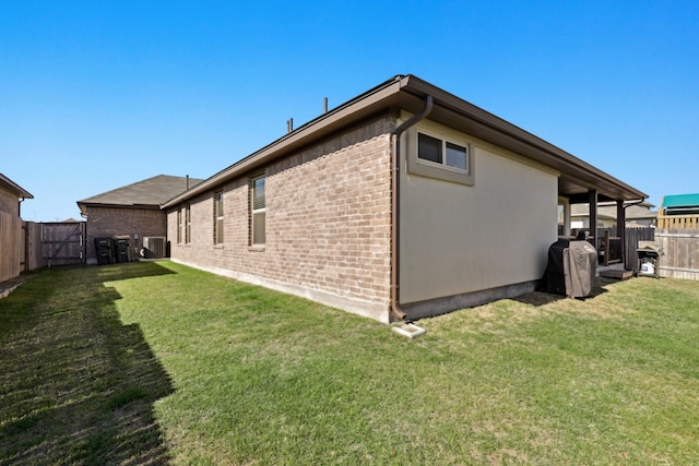 185 Dogvane Cir, Kyle, TX 78640 - view of property exterior featuring brick siding and central AC unit