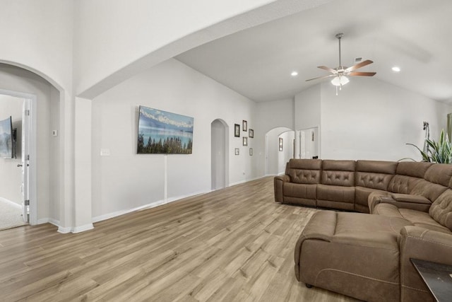 185 Dogvane Cir, Kyle, TX 78640 - living room with a ceiling fan, light wood-style floors, arched walkways, recessed lighting, and high vaulted ceiling