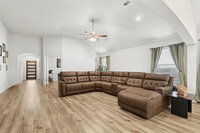 185 Dogvane Cir, Kyle, TX 78640 - living area featuring arched walkways, a ceiling fan, light wood-style floors, and vaulted ceiling