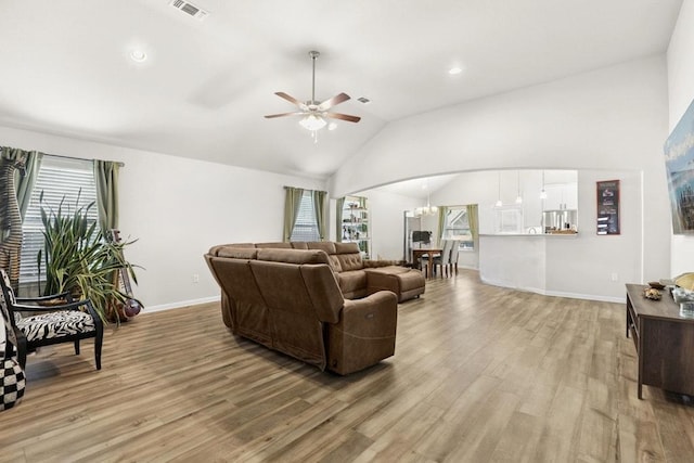 185 Dogvane Cir, Kyle, TX 78640 - living area featuring light wood-style flooring, ceiling fan, lofted ceiling, baseboards, and arched walkways