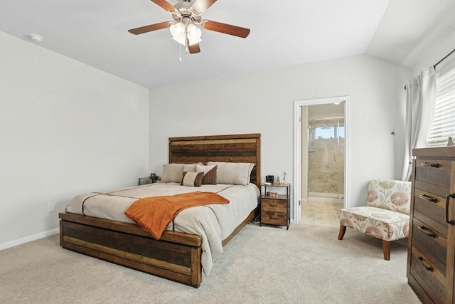 185 Dogvane Cir, Kyle, TX 78640 - bedroom featuring carpet, lofted ceiling, baseboards, ensuite bath, and a ceiling fan