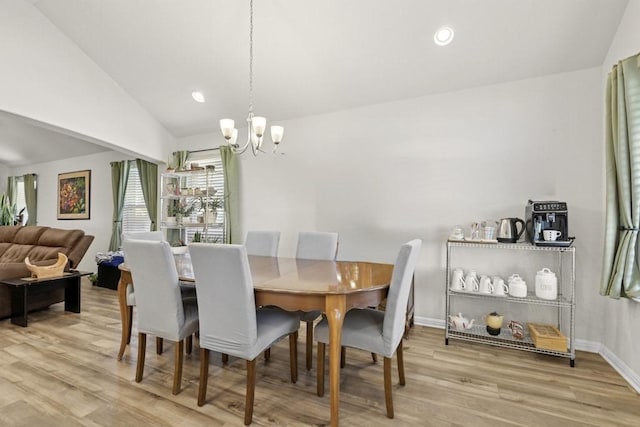 185 Dogvane Cir, Kyle, TX 78640 - dining area with a chandelier, wood finished floors, vaulted ceiling, and baseboards