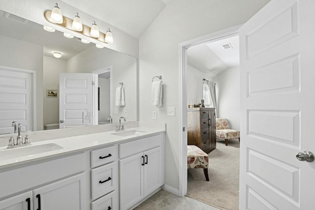 185 Dogvane Cir, Kyle, TX 78640 - ensuite bathroom with lofted ceiling, toilet, double vanity, and marble finish flooring