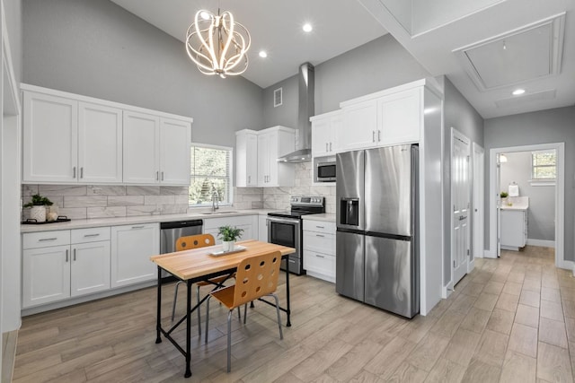 23315 Nameless Rd, Leander, TX 78641 - kitchen featuring a sink, light countertops, white cabinets, appliances with stainless steel finishes, and a high ceiling