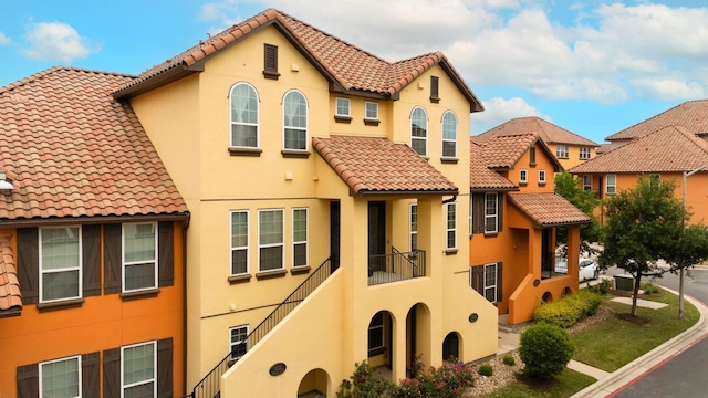view of front of property featuring a tile roof and stucco siding
