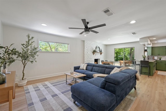 living room with plenty of natural light, visible vents, and light wood-style flooring