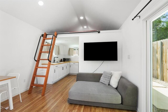 interior space with recessed lighting, light wood-style floors, and lofted ceiling