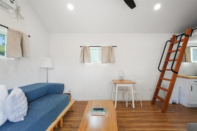 living area featuring recessed lighting, wood finished floors, and baseboards