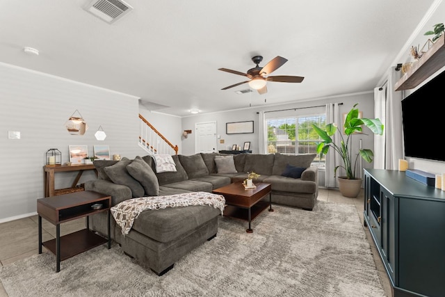 1505 Balsam Way, Round Rock, TX 78665 - living area with ceiling fan, stairs, crown molding, and baseboards