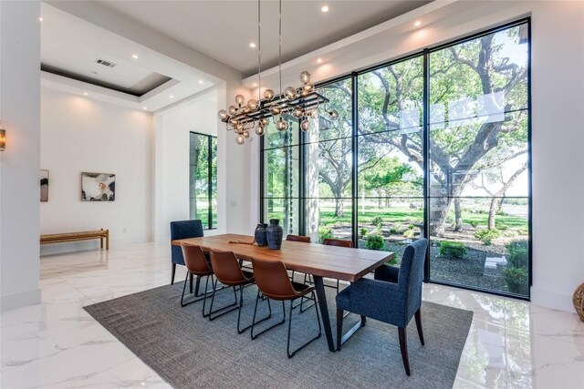 dining area featuring a chandelier, visible vents, marble finish floor, and recessed lighting