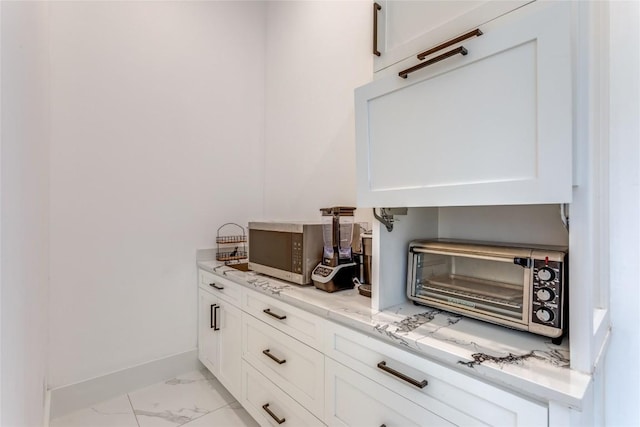 116 Mesones Rd, Florence, TX 76527 - bar area with light marble finish floors and stainless steel microwave