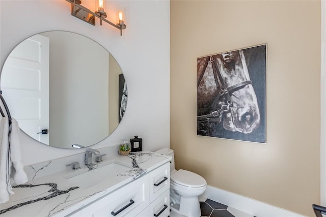 bathroom featuring toilet, vanity, and tile patterned floors