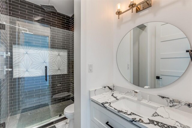 full bathroom with vanity, toilet, and a stall shower