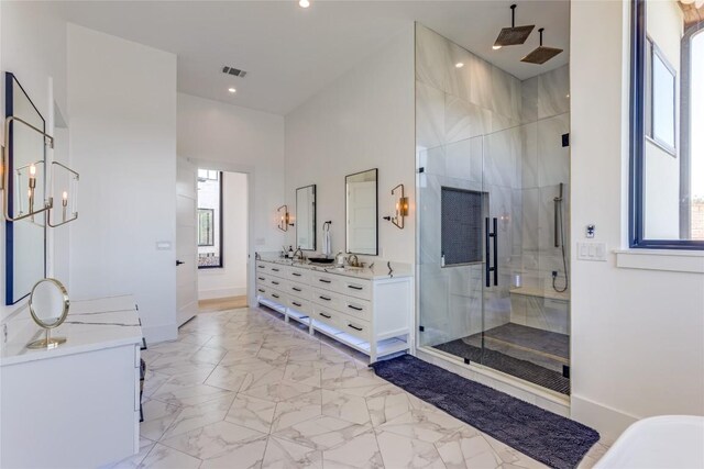 bathroom featuring a shower stall, a wealth of natural light, and visible vents