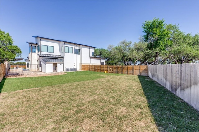 116 Mesones Rd, Florence, TX 76527 - back of house featuring a standing seam roof, a fenced backyard, a metal roof, and stucco siding