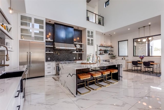 116 Mesones Rd, Florence, TX 76527 - kitchen with high quality appliances, open shelves, light stone counters, backsplash, and a kitchen breakfast bar