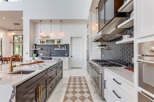 kitchen featuring open shelves, a sink, decorative backsplash, white cabinets, and appliances with stainless steel finishes